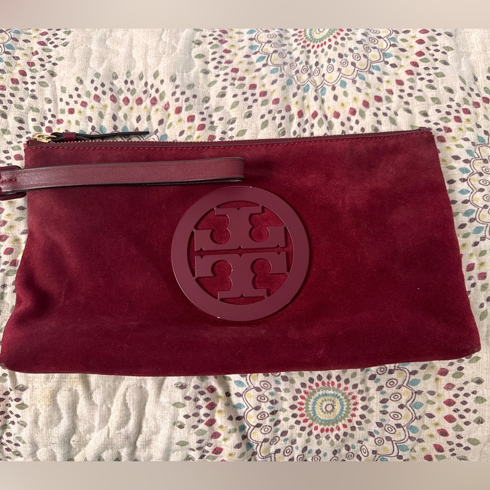 Tory Burch suede and leather clutch with wristlet strap.